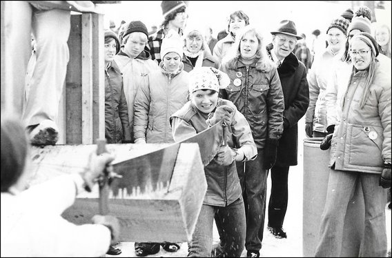 image: Barb Knight races to saw a piece of timber at Foresters Day in the 1970s.
