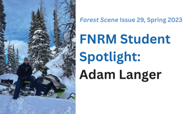 A young student rests on his snowmobile in front of snow-covered trees.
